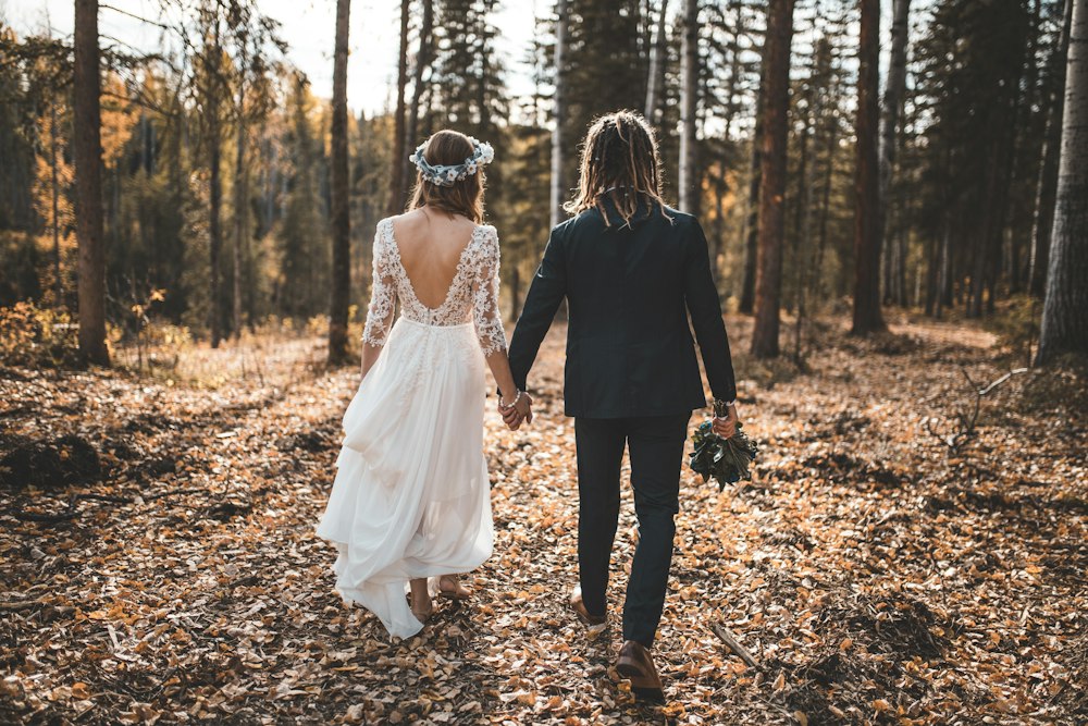 A bride and groom walking together outdoors